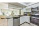 Stylish kitchen with stainless steel appliances and granite counters open to the dining area at 1818 Kim Acres Ln, Dover, FL 33527