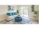 Cozy living room featuring a sliding glass door, a comfy couch with colorful pillows at 1818 Kim Acres Ln, Dover, FL 33527