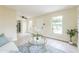 Bright living room with a view of the front yard, tile floors, and neutral walls at 1818 Kim Acres Ln, Dover, FL 33527