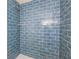 Close-up of walk-in shower with blue subway tiles and silver hardware at 1818 Kim Acres Ln, Dover, FL 33527