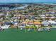 Aerial view of waterfront home with pool, dock, and boat lift on a sunny day at 191 1St W St, St Petersburg, FL 33715