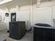 A close up shot of two air conditioners on a tiled base outside the home at 191 1St W St, Tierra Verde, FL 33715