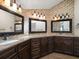 Spacious bathroom featuring dual sinks, granite countertops, and mosaic tile accents at 191 1St W St, Tierra Verde, FL 33715