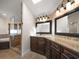 Spa-like bathroom with a large vanity, ornate framed mirrors, and a walk-in shower at 191 1St W St, Tierra Verde, FL 33715
