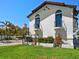 Exterior elevation of estate home with balconies, arched windows and lush landscaping at 191 1St W St, Tierra Verde, FL 33715