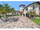 Beautiful, luxurious home with a tile roof, tower and mature landscaping at 191 1St W St, Tierra Verde, FL 33715