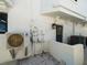 Exterior of home featuring white walls, A/C unit, door and a light fixture at 191 1St W St, Tierra Verde, FL 33715