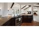 Open kitchen design featuring a stainless steel stove, dark wood cabinetry, and granite countertops at 191 1St W St, Tierra Verde, FL 33715