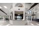 Open floor plan kitchen, with granite countertop island, looking out to expansive living area with fireplace at 191 1St W St, Tierra Verde, FL 33715