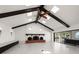 Spacious living room featuring high ceilings with wood beams, a brick fireplace, and water views at 191 1St W St, Tierra Verde, FL 33715