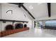 Bright living room boasts beamed ceilings, a brick fireplace, and access to an outdoor balcony with water views at 191 1St W St, Tierra Verde, FL 33715