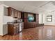 Spacious living room features a wet bar, built-in entertainment center, and tile flooring at 191 1St W St, Tierra Verde, FL 33715