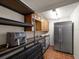 Pantry area with stainless steel refrigerator, overhead cabinets and black shelving at 191 1St W St, Tierra Verde, FL 33715