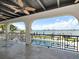 Covered patio showing black ceiling fans, columns, black railings with water views at 191 1St W St, Tierra Verde, FL 33715