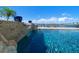 Waterfront swimming pool with rock feature, water feature, and palm trees at 191 1St W St, Tierra Verde, FL 33715