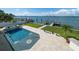 Beautiful pool with a compass inlay and stunning water views, perfect for relaxing and entertaining at 191 1St W St, Tierra Verde, FL 33715