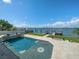 Breathtaking waterfront pool with a spa, boat dock, and stunning views of the bay and skyline at 191 1St W St, Tierra Verde, FL 33715