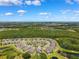 Aerial view of community with ponds, abundant trees, and houses in a circular formation at 19323 Hawk Valley Dr, Tampa, FL 33647