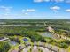 An aerial view of a neighborhood surrounded by ponds, roadways, and vast green spaces at 19323 Hawk Valley Dr, Tampa, FL 33647