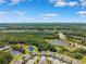 Aerial view showcasing a community near lush greenery, ponds, and a highway at 19323 Hawk Valley Dr, Tampa, FL 33647