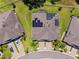 Aerial view of a home with solar panels, manicured lawn, and a paved driveway at 19323 Hawk Valley Dr, Tampa, FL 33647