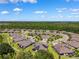An aerial view of a community featuring houses with solar panels and surrounded by ponds and trees at 19323 Hawk Valley Dr, Tampa, FL 33647