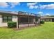 Lush backyard with a screened-in lanai, perfect for relaxing and outdoor activities at 19323 Hawk Valley Dr, Tampa, FL 33647