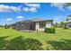 Expansive backyard with green grass and a screened-in lanai, ideal for outdoor living at 19323 Hawk Valley Dr, Tampa, FL 33647