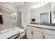Modern bathroom featuring subway tiles in the shower and a large vanity mirror at 19323 Hawk Valley Dr, Tampa, FL 33647