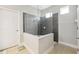 Modern shower with glass enclosure, gray tiling, and sleek fixtures for a luxurious bathing experience at 19323 Hawk Valley Dr, Tampa, FL 33647
