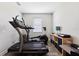 Bright exercise room featuring wood floors and modern equipment, like a treadmill at 19323 Hawk Valley Dr, Tampa, FL 33647