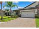 Beautiful single-Gathering home featuring a large driveway and well-manicured lawn at 19323 Hawk Valley Dr, Tampa, FL 33647