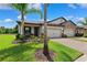 Charming home exterior with a two-car garage and a well-manicured front yard at 19323 Hawk Valley Dr, Tampa, FL 33647