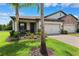 Charming home featuring a 2-car garage, beautiful landscaping, and a paved driveway at 19323 Hawk Valley Dr, Tampa, FL 33647