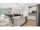 Open kitchen with a large island, granite countertops, and stainless steel appliances at 19323 Hawk Valley Dr, Tampa, FL 33647