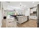 Open-concept kitchen featuring an island, modern appliances, and seamless connection to the living area and screened porch at 19323 Hawk Valley Dr, Tampa, FL 33647