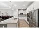 Modern kitchen with white cabinets, stainless steel appliances, and tile backsplash at 19323 Hawk Valley Dr, Tampa, FL 33647