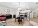 A kitchen featuring white cabinetry, stone countertops, pendant lighting, and connection to the dining and living space at 19323 Hawk Valley Dr, Tampa, FL 33647