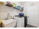 Well-organized laundry room with stainless steel washer/dryer and ample shelving at 19323 Hawk Valley Dr, Tampa, FL 33647