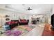 Spacious open-plan living area with modern furnishings, colorful rug, and seamless flow to kitchen and dining at 19323 Hawk Valley Dr, Tampa, FL 33647