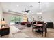 Inviting living room with a ceiling fan, colorful rug, sliding doors to the screened porch, and easy access to dining at 19323 Hawk Valley Dr, Tampa, FL 33647