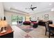 An inviting living room with access to a screened porch, accented by a colorful rug and comfortable seating at 19323 Hawk Valley Dr, Tampa, FL 33647