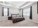 Serene main bedroom with tray ceilings, plush carpeting, and large windows providing natural light at 19323 Hawk Valley Dr, Tampa, FL 33647