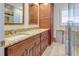 Bathroom with double vanity, granite countertop, and tiled walk-in shower at 2017 Iowa Ne Ave, St Petersburg, FL 33703