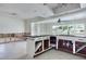 Open kitchen featuring an island, granite countertops, and white cabinetry awaiting your design ideas at 2017 Iowa Ne Ave, St Petersburg, FL 33703