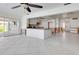 Spacious living area and kitchen featuring an island, granite countertops, and white cabinetry ready for updates at 2017 Iowa Ne Ave, St Petersburg, FL 33703