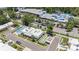 Bird's-eye view of a community center featuring a pool, water park, and ample parking, surrounded by trees at 202 Mindy Dr, Largo, FL 33771
