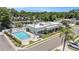 Stunning aerial view of a community pool and clubhouse surrounded by manicured landscaping and lush greenery at 202 Mindy Dr, Largo, FL 33771