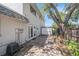 A serene backyard featuring a brick patio, white fencing and lush greenery, offering a peaceful retreat at 202 Mindy Dr, Largo, FL 33771