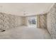 Spacious bedroom with sliding glass doors to the balcony and neutral carpeting at 202 Mindy Dr, Largo, FL 33771